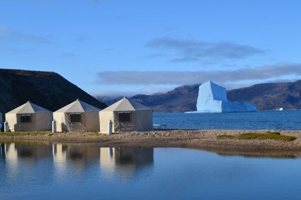 Yurts in the arctic with glacier in the background
