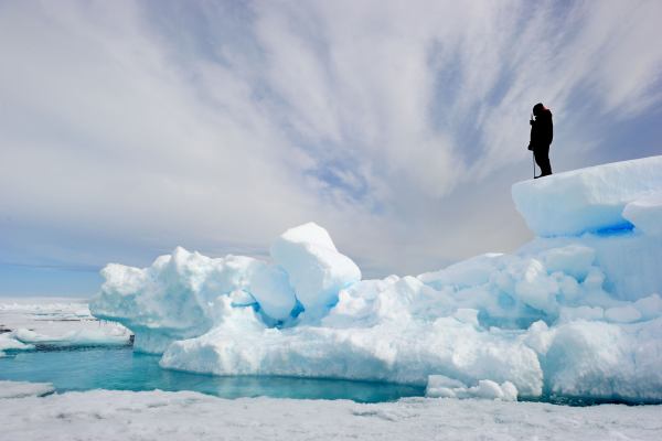 Man standing on glacier in the arctic