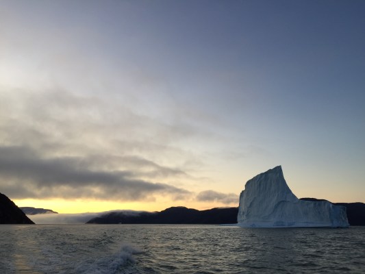 arctic ocean with glacier and sunset