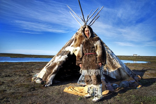 Inuit person in front of teepee