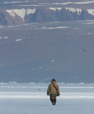 Inuit walking in the arctic