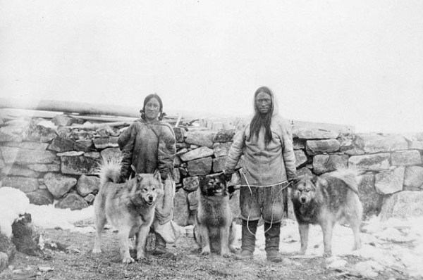 Inuits with dogs in the arctic