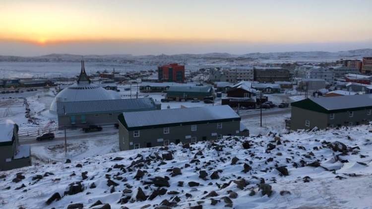 city of Iqaluit with a sunset in the background