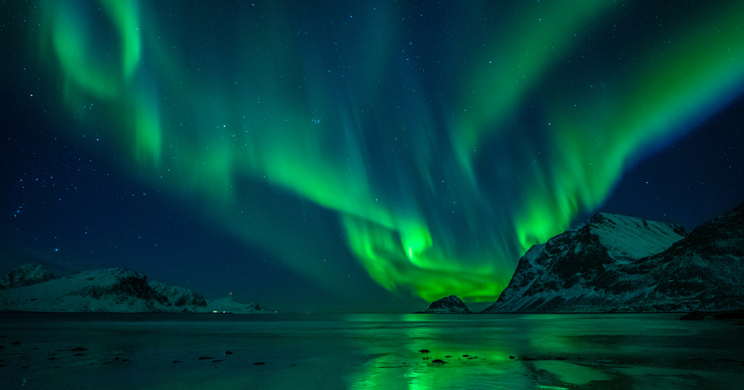 a photo of the Arctic landscape with Northern Lights showing in the sky